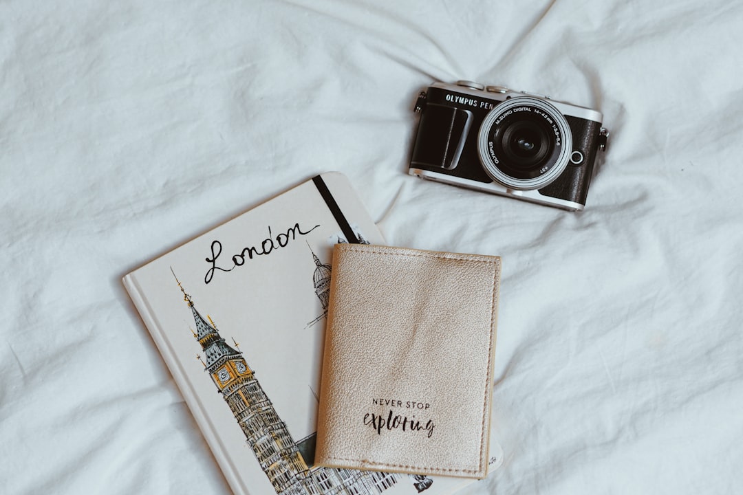 Elegant travel planning materials with leather journal and dried flowers