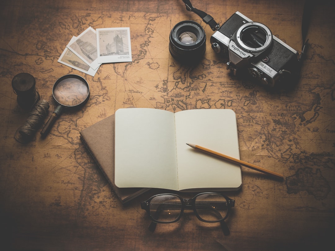 Travel planning materials with camera and notebook