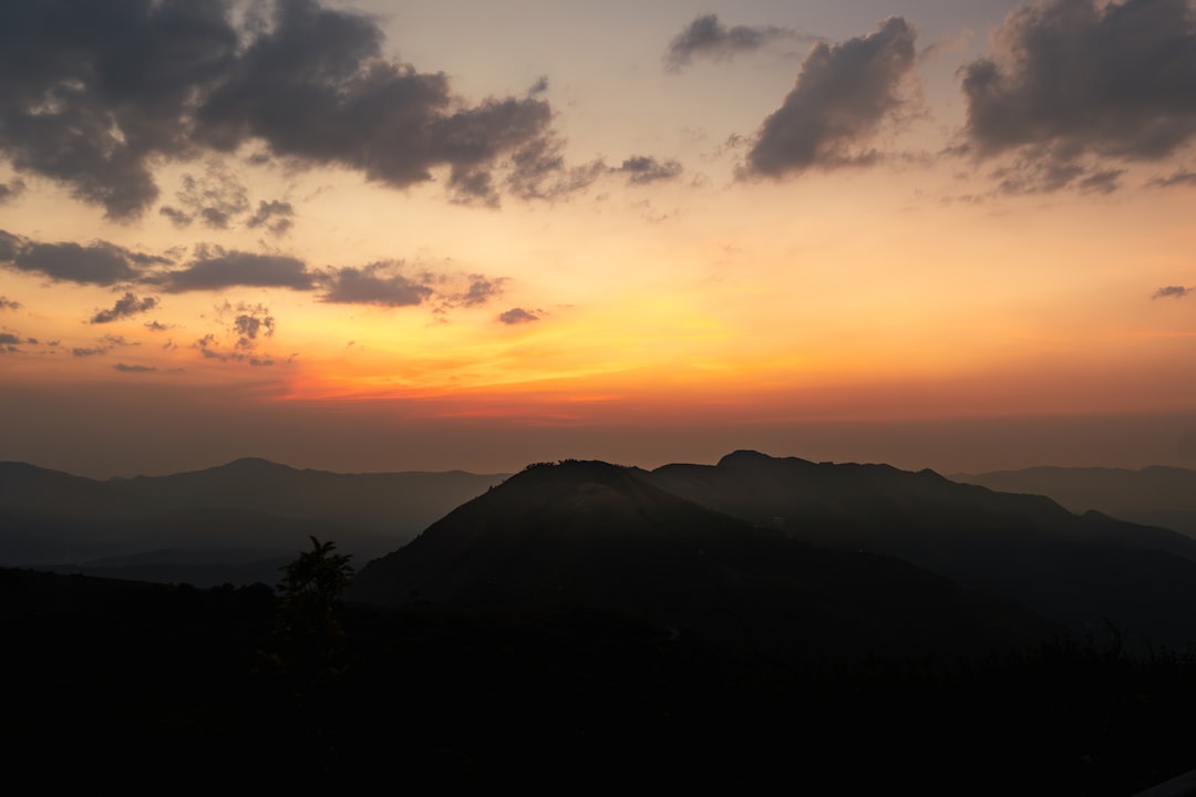 Traveler overlooking scenic landscape at sunset